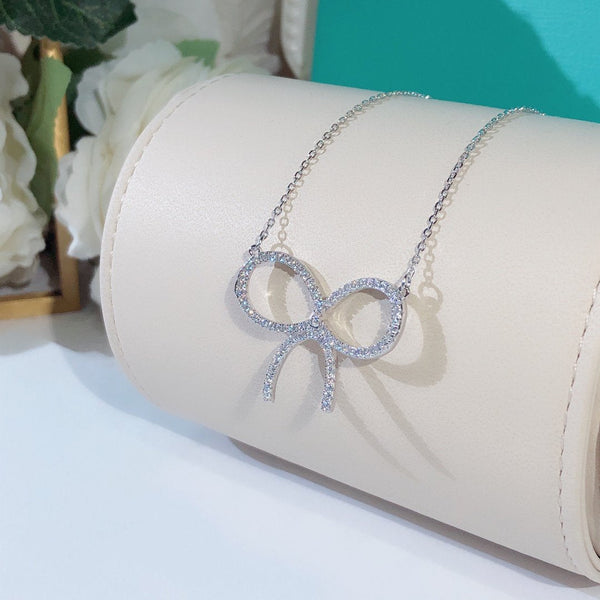 CLAW SET RHODIUM PLATED BOW NECKLACE