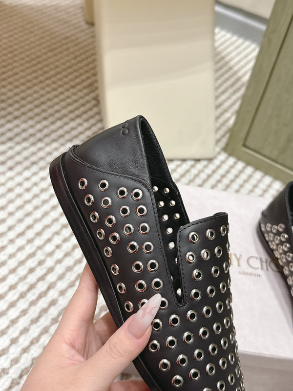 Mules plates Jimmy Choo Eliot Œillets métalliques Cuir de veau noir 568492