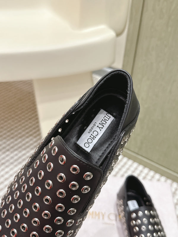 Mules plates Jimmy Choo Eliot Œillets métalliques Cuir de veau noir 568492