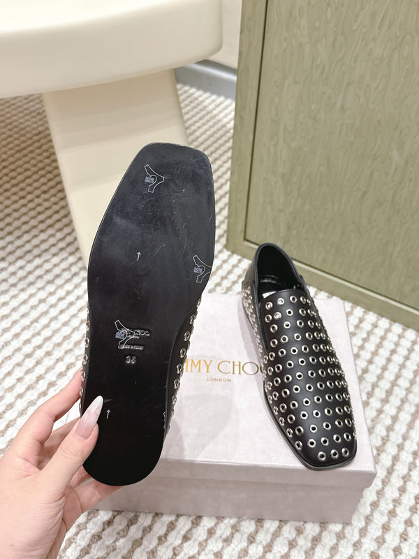 Mules plates Jimmy Choo Eliot Œillets métalliques Cuir de veau noir 568492