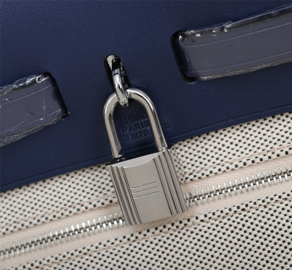 HM HERBAG ZIP 31 NAVY AND CREAM MONOGRAM CANVAS