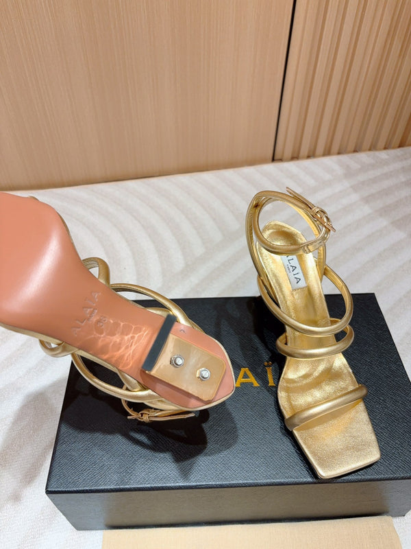 ALAIA THREE-STRAPS HIGH HEEL SANDALS IN GOLDEN PATENT LAMBSKIN