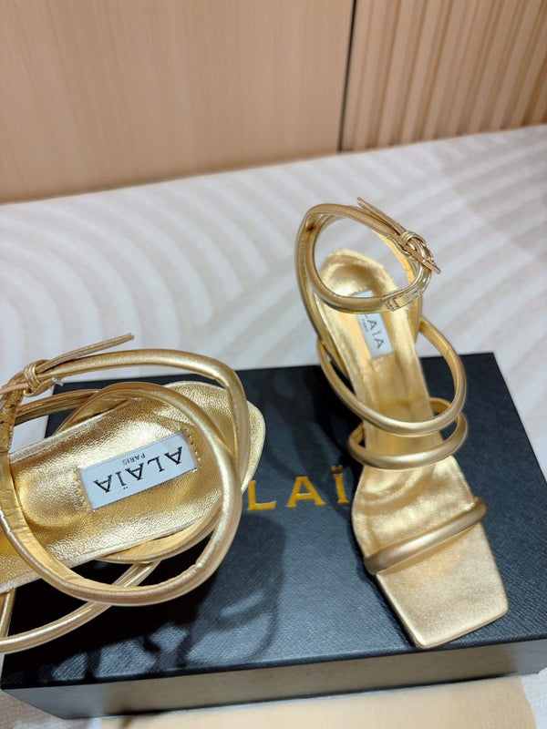 ALAIA THREE-STRAPS HIGH HEEL SANDALS IN GOLDEN PATENT LAMBSKIN