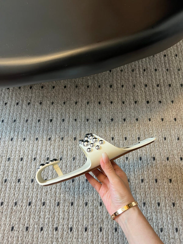 ALAIA FOLDED FLAT MULES WITH SPHERES ON WHITE CALFSKIN