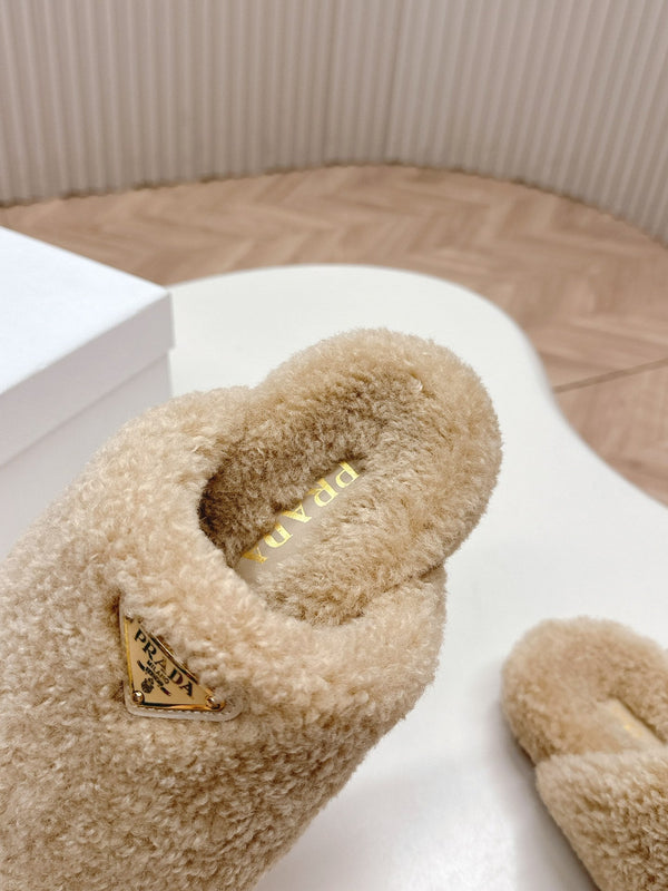 MULES CON LOGO TRIANGOLARE ATTACCATO IN SHEARLING BEIGE