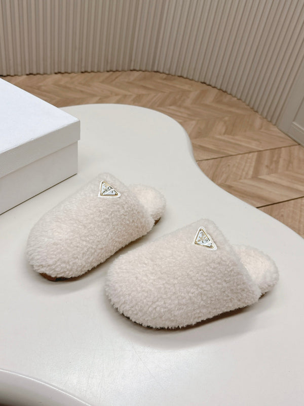 MULES CON LOGO TRIANGOLARE ATTACCATO IN SHEARLING BIANCO