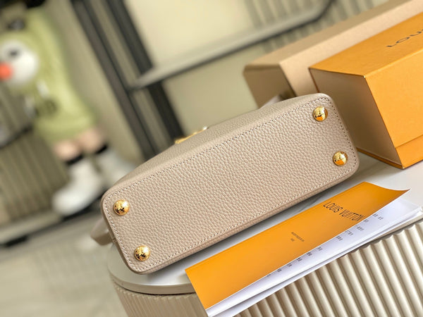 CAPUCINES BB 27 DARK BEIGE TAURILLON GOLD HARDWARE