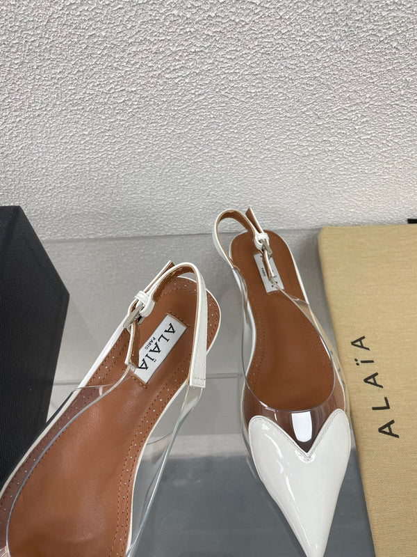 ALAIA LE COEUR FLAT SLINGBACKS IN WHITE PATENT LAMBSKIN
