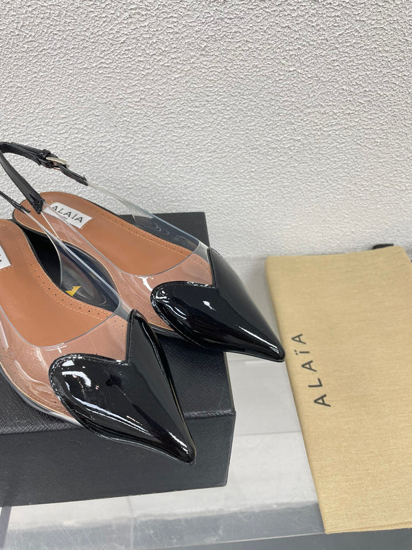ALAIA LE COEUR FLAT SLINGBACKS IN BLACK PATENT LAMBSKIN