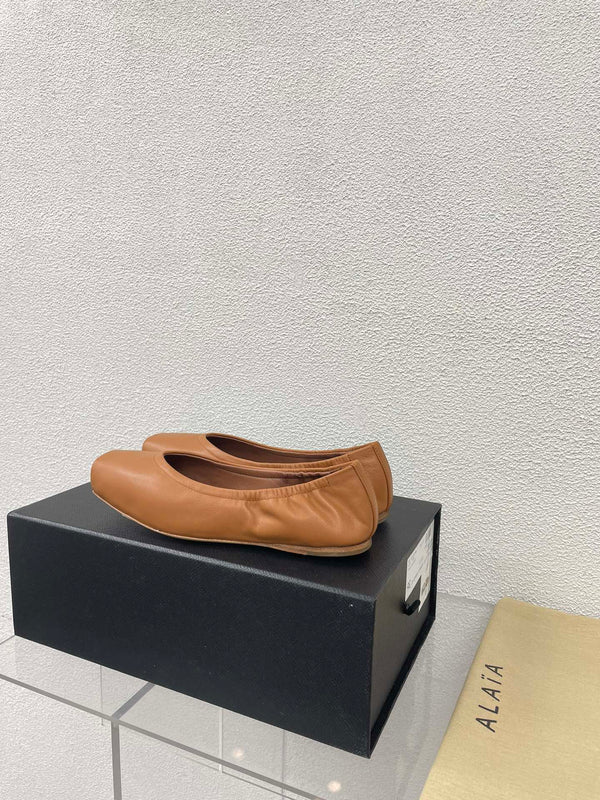 ALAIA BALLET FLATS IN COPPER BROWN CALFSKIN