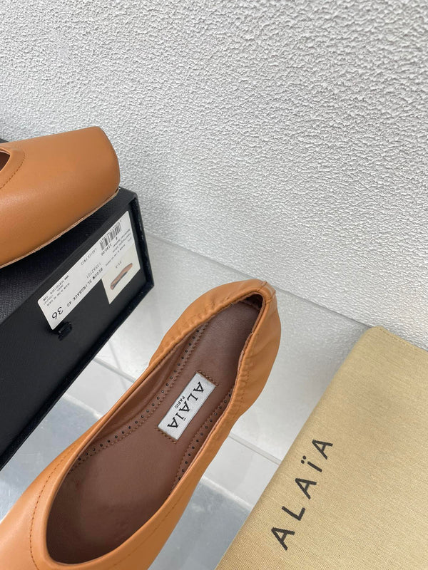 ALAIA BALLET FLATS IN COPPER BROWN CALFSKIN