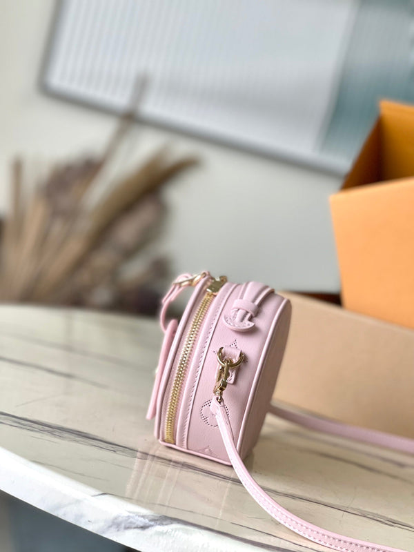 MINI BOITE CHAPEAU 13 IN PELLE DI VITELLO TRAFORATA CON MONOGRAMMA ROSA CHIARO