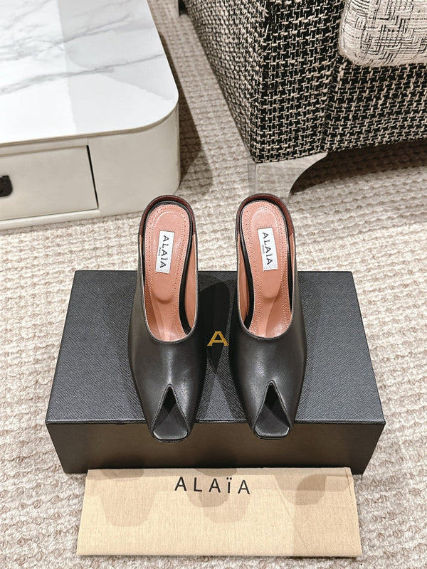 ALAIA SPIKE JEWEL MULES IN BLACK CALFSKIN
