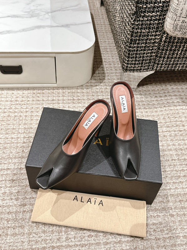 ALAIA SPIKE JEWEL MULES IN BLACK CALFSKIN