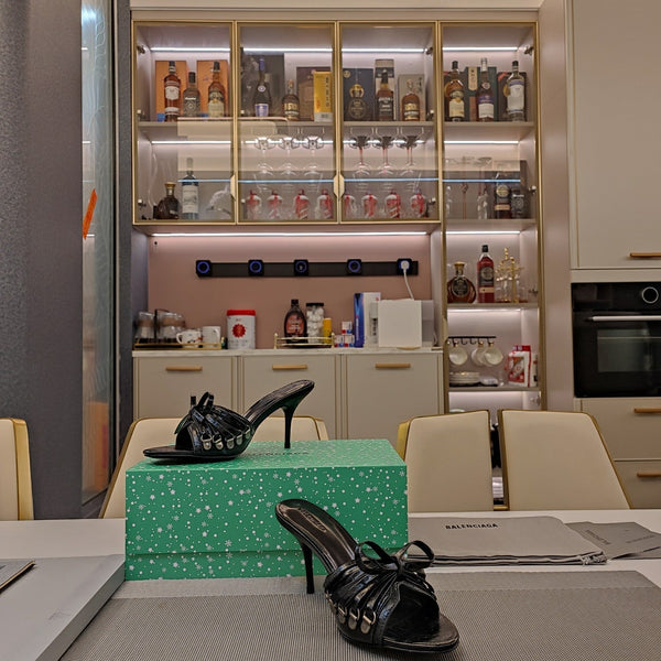 BOW-EMBELLISHED HIGH MULES IN BLACK SHEEPSKIN