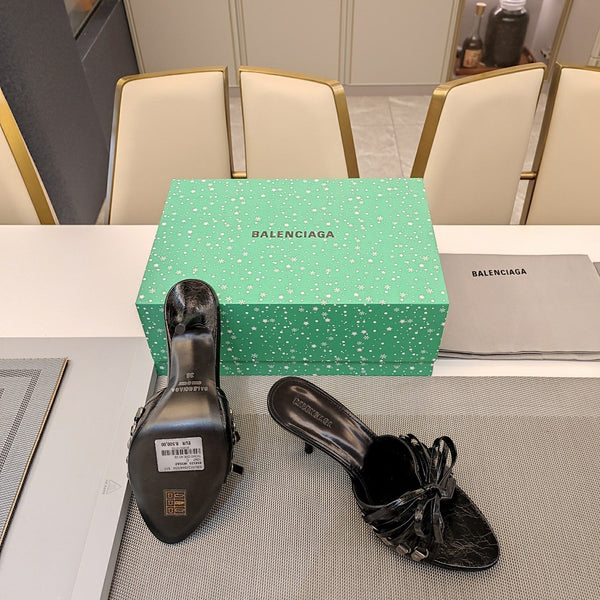 BOW-EMBELLISHED HIGH MULES IN BLACK SHEEPSKIN