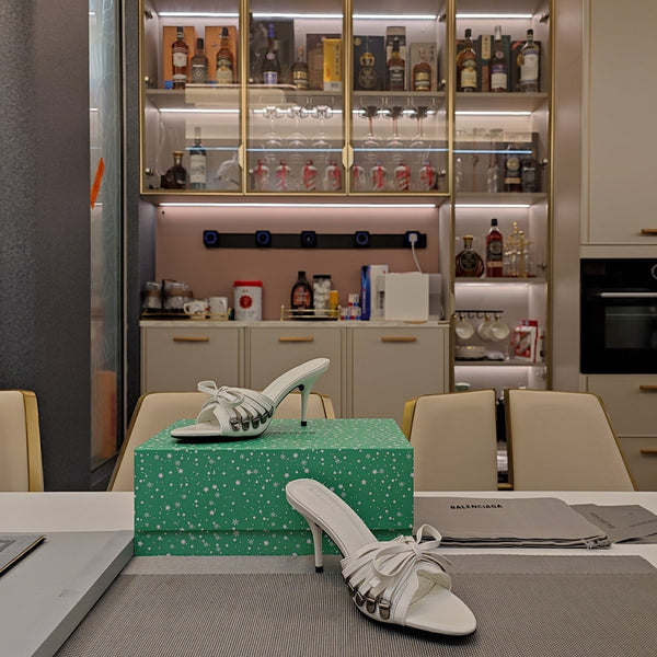 BOW-EMBELLISHED HIGH MULES IN WHITE SHEEPSKIN