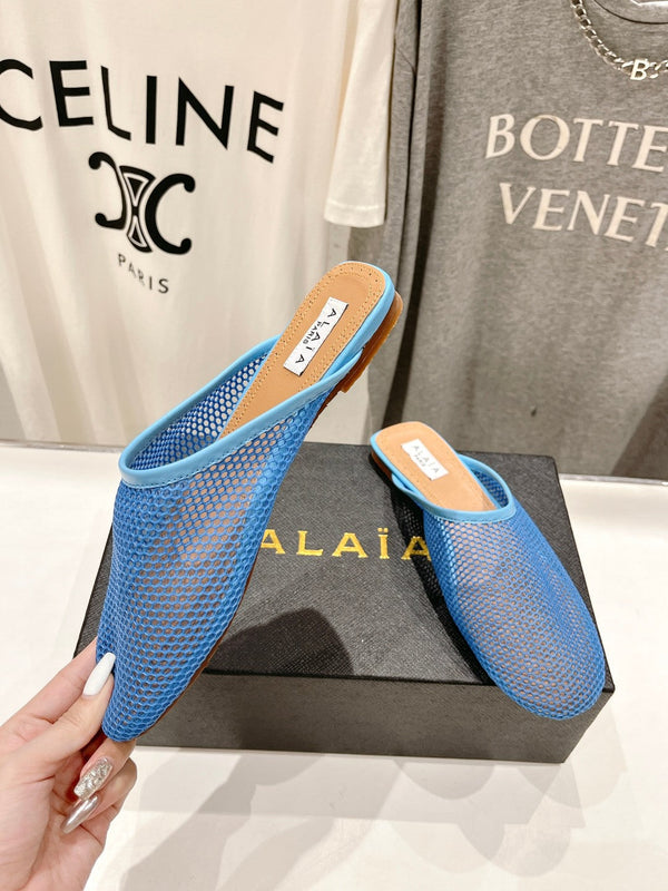 ALAIA FLAT MULES IN CERULEAN BLUE MESH FISHNET