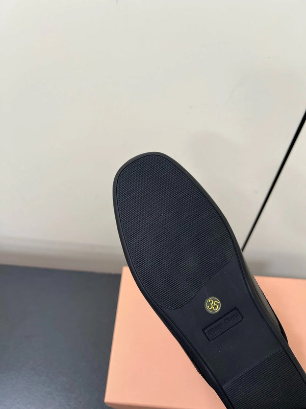 BOW MULES IN BLACK SHEEPSKIN