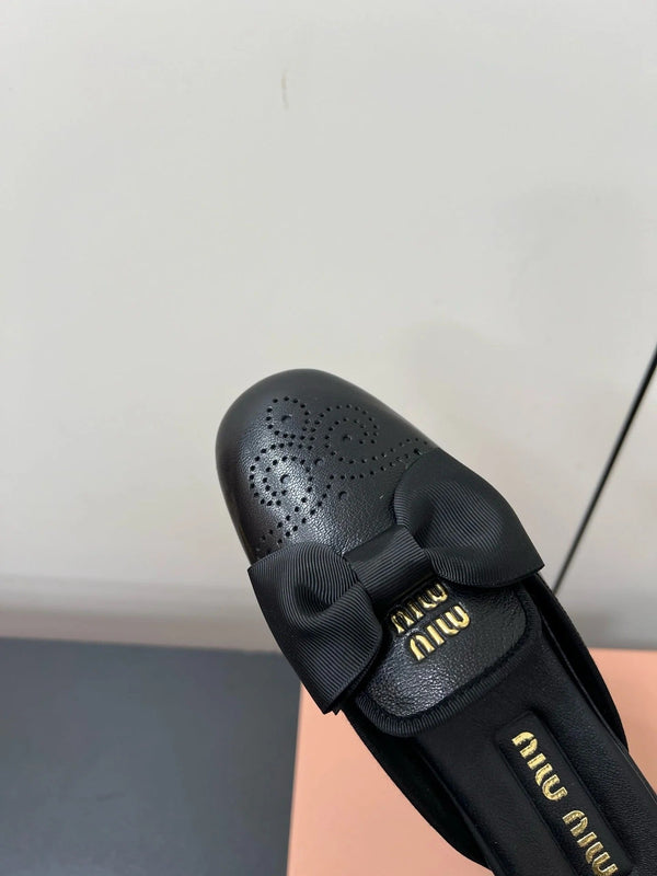 BOW MULES IN BLACK SHEEPSKIN