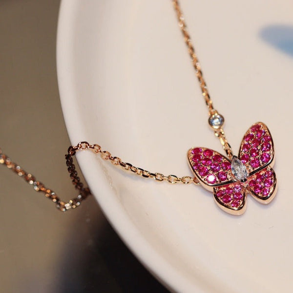 COLLANA IN ORO ROSA CON DIAMANTI ROSSI A FARFALLA
