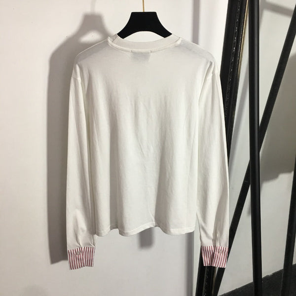 T-shirt à manches longues et col rond Chanel avec blocs de couleurs et rayures, et poche