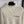 Top en maille à manches longues avec pompon et collier doré en métal siglé Chanel