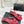 Sandales Chanel 26C à talon carré avec nœud chaîne, rouges, en cuir de vachette 615987