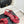 Sandales Chanel 26C à talon carré avec nœud chaîne, rouges, en cuir de vachette 615987