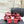 Sandales Chanel 26C à talon carré avec nœud chaîne, rouges, en cuir de vachette 615987