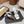 ALAIA TWO-STRAPS HIGH HEEL SANDALS IN WHITE PATENT LAMBSKIN
