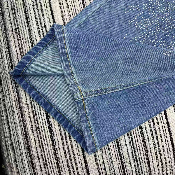 Jean droit Chanel 2026 avec logo double C et ornements en strass