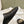 FLAT MULES IN BLACK SMOOTH CALFSKIN GOLD BUCKLE