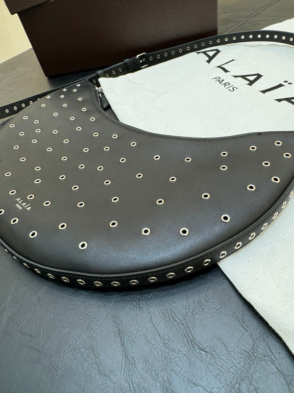 ONE PIECE DEMI LUNE BAG 31 IN BLACK SHEEPSKIN EYELET DETAILING