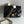 Mini borsa con patta 17 cm in pelle di agnello nera con finiture dorate 