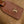 CARRYALL PM 29 IN CIDER BROWN MONOGRAM PERFORATED SUEDE AND WHITE SHEARLING TRIM