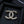 DOUBLE C BROOCH IN GOLD METAL WITH BLACK LEATHER THREADED CHAIN