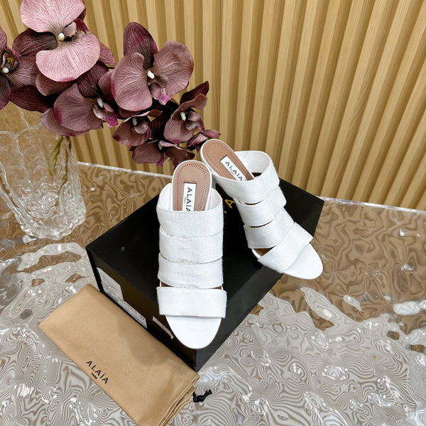 SANDALI ALAIA ELASTIC CAGE MULE IN CINTURINO INTRECCIATO BIANCO E PELLE DI AGNELLO