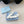 DÉCOLLETÉ CON CINTURINO SLINGBACK E FIOCCO CON LOGO TRIANGOLARE IN PELLE DI VITELLO BIANCA