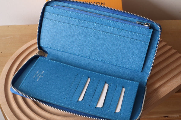 Portafoglio verticale LV Zippy in tela monogramma blu e pelle Taiga 180068