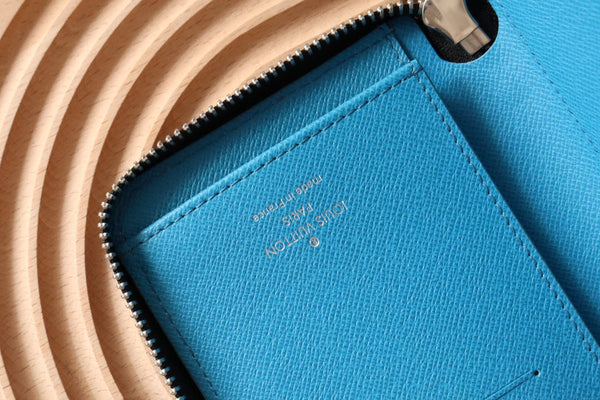Portafoglio verticale LV Zippy in tela monogramma azzurro e pelle Taïga 180051