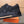 LV TRAINER IN EMBOSSED BLACK SUEDE