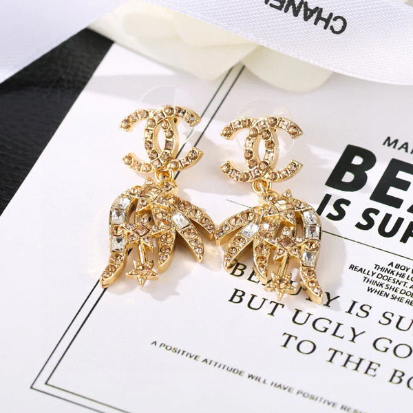 Boucles d'oreilles pendantes CC Strass Star en or et diamant