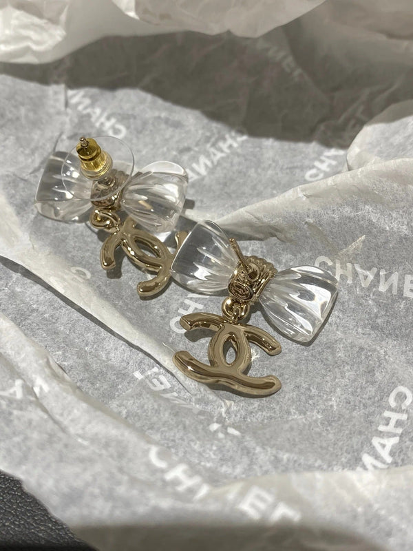 Boucles d'oreilles nœud en acrylique transparent CC doré