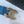 DOUBLE C ELASTIC BELT 30MM IN BLUE DENIM WITH GOLD BUCKLE AND SIDE RHINESTONE DETAILING